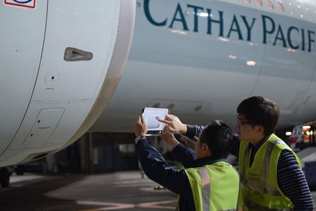 Engineers field test the use of tablets to measure damage to the aircraft’s shell. Cathay Pacific is also testing how to mount the sensors on drones. Photo: Handout