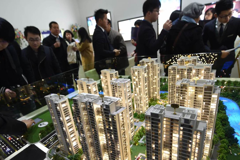 Gains for mainland Chinese property developer shares helped to push China’s leading stock indexes into positive territory on Friday. In this photo, potential buyers visit a house and auto expo in Hangzhou on November 27. Photo: Xinhua