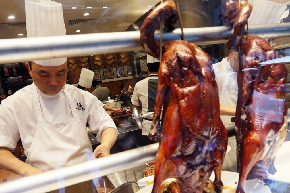 A chef serves up another helping of the signature roast goose at Yung Kee Restaurant in Central. Photos: Felix Wong