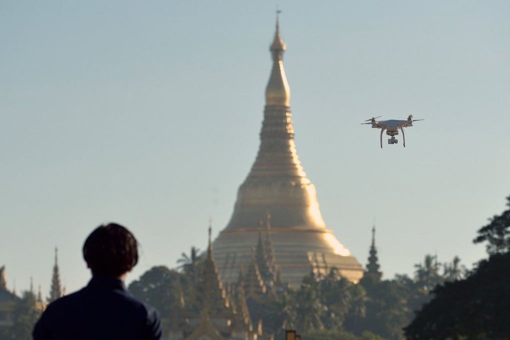 A drone enthusiast pilots his remote controlled aircraft at a park in Yangon. Photo: AFP