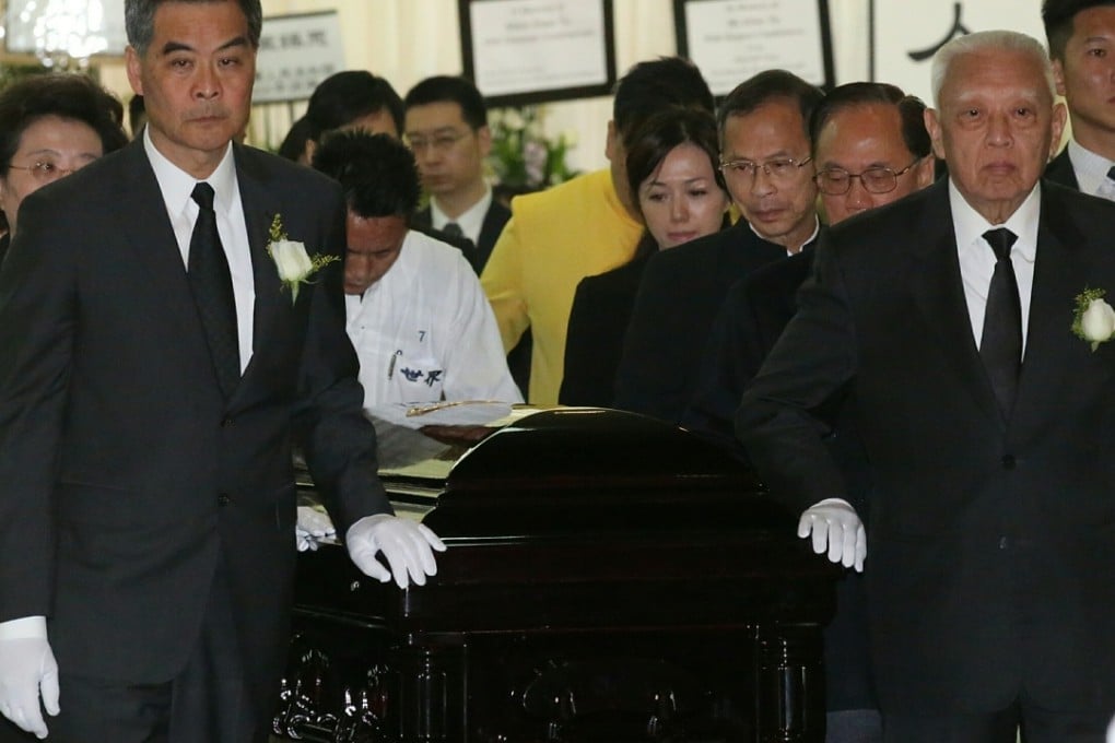 Pallbearers including Chief Executive Leung Chun-ying with former CEs Tung Chee-hwa and Donald Tsang Yam-kuen lead the coffin out of Universal funeral parlour, Hung Hom. Photo: Edward Wong