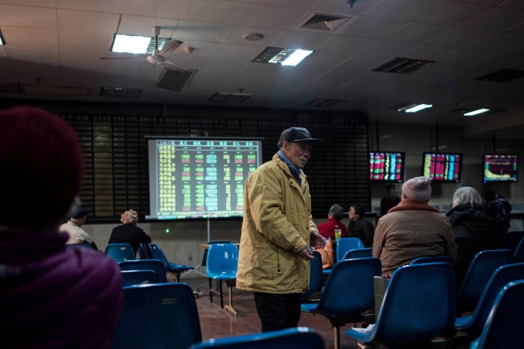 Investors monitor screens showing stock market movements at a brokerage house in Shanghai. Photo: AFP