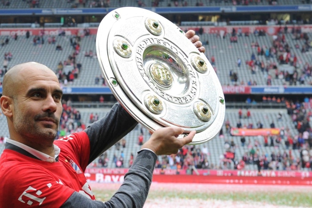 Pep Guardiola, who has won a combined 19 trophies with Bayern Munich and Barcelona, with the trophy after Bayern won their 25th Bundesliga title in May this year. Photo: AFP