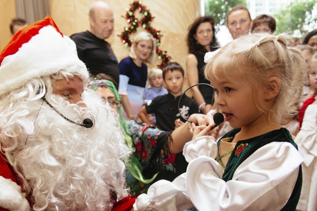 Nicole Bezverkha with Uncle Frost at Ladushki’s annual New Year Carnival in Hong Kong.
