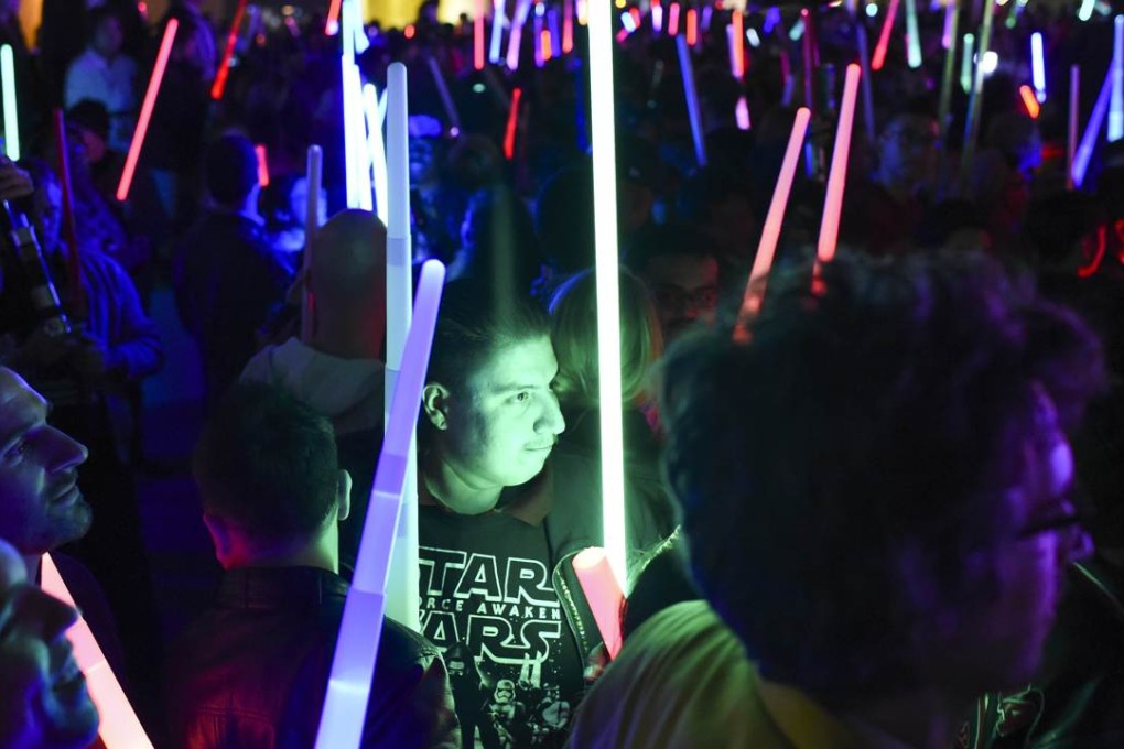 Star Wars fans raise their lightsabers during Lightsaber Battle LA in Pershing Square in downtown Los Angeles, California on Friday. Photo: AFP