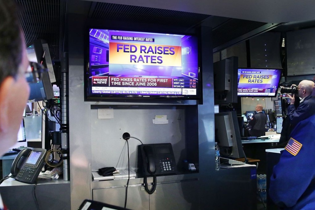 Traders on the floor of the New York Stock Exchange (NYSE) as the Federal Reserve announced it was raising interest rates for the first time in nearly a decade. Photo: AFP