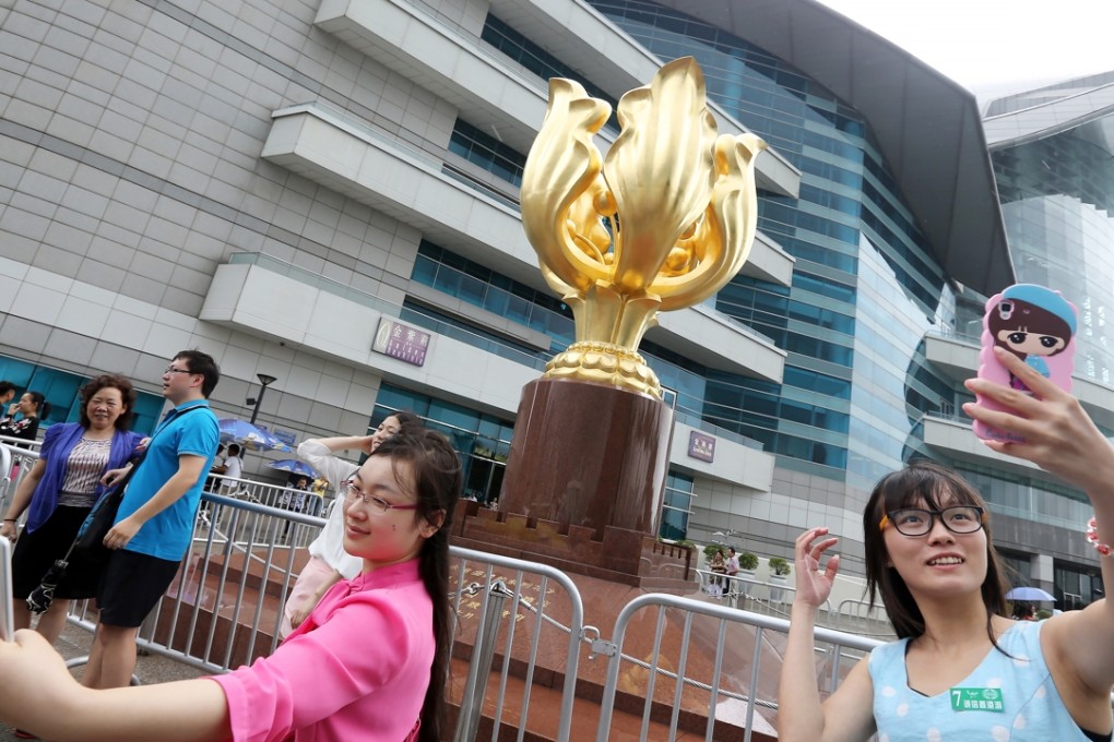 Tourists take selfies at Bauhinia Square in Wan Chai during the “Golden Week” holiday. Photo: SCMP Pictures