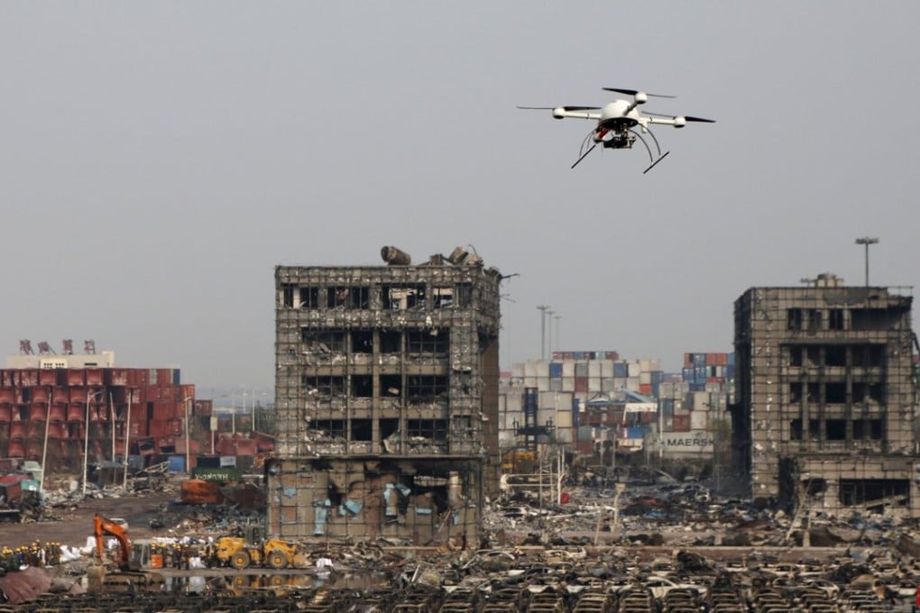 A drone operated by paramilitary police flies over the site of August 12, 2015 explosions at Binhai new district in Tianjin, China. Photo: Reuters