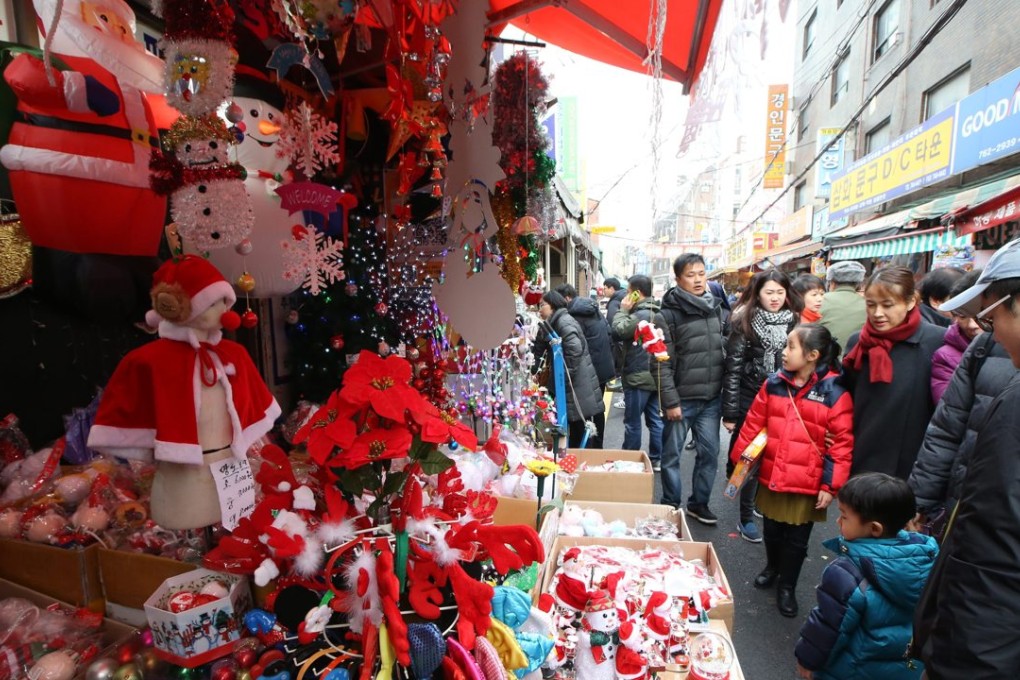 Locals shop for Christmas gifts at a toy market in northern Seoul, South Korea. Photo: EPA