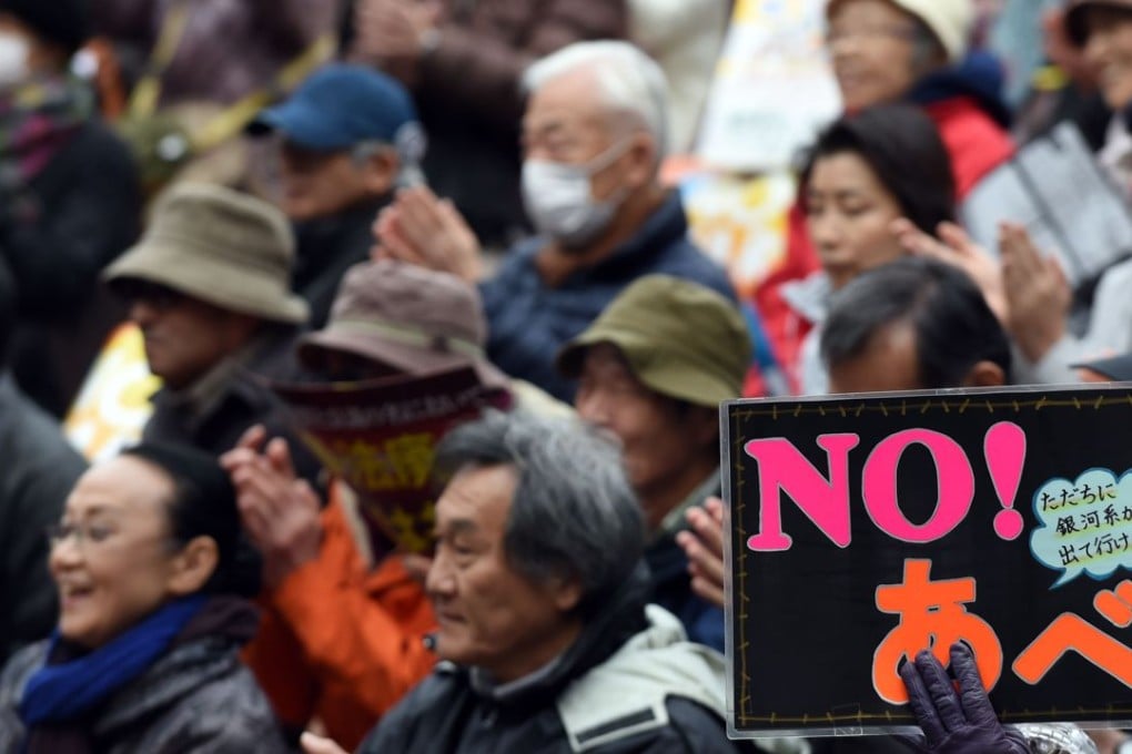 A protester holds a banner saying “No Abe” at a rally in Tokyo this month. Many Japanese oppose new security laws that open the door for Japanese troops to engage in combat overseas for the first time since the end of the second world war. Photo: AFP