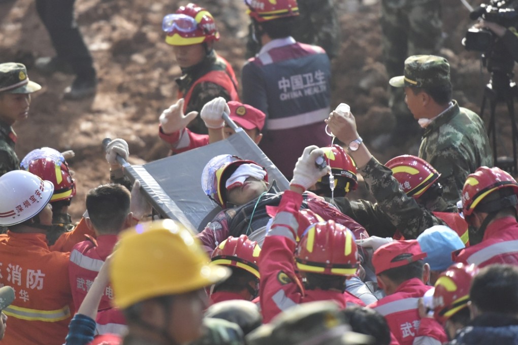 Rescue workers pull the survivor Tian Zeming from the debris early on Wednesday morning following Sunday’s landslide in Shenzhen. Photo: Xinhua