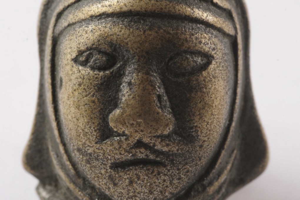 A bronze belt ornament depicting the face of a Xiongnu warrior, from The Great Wall in 50 Objects.