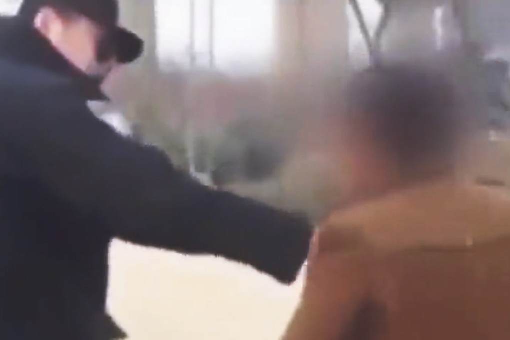 A still from the video, reportedly showing a Chinese auxiliary policeman holding a young man by the throat in Shandong province. Photo: SCMP Pictures