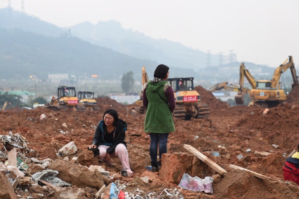 A woman looks for her missing sister and her sister's child at the site of landslide at an industrial park in Shenzhen on December 21. Photo: Xinhua
