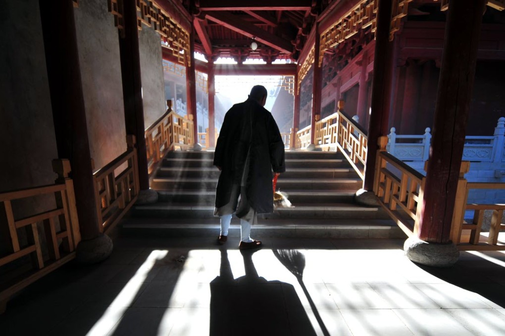 A Buddhist nun performs her morning chores at Wutaishan, literally "Five Plateau Mountain", in Shanxi province. There are no official figures on the number of Buddhists throughout the country but the Pew Research Centre estimates there were more than 244 million in 2010, half the total worldwide. Photo: AFP
