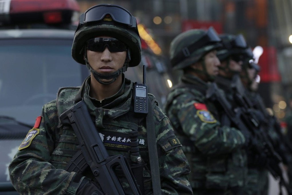 Armed Chinese paramilitary police stand guard outside a shopping mall in Sanlitun on Christmas Eve in Beijing. Photo: EPA
