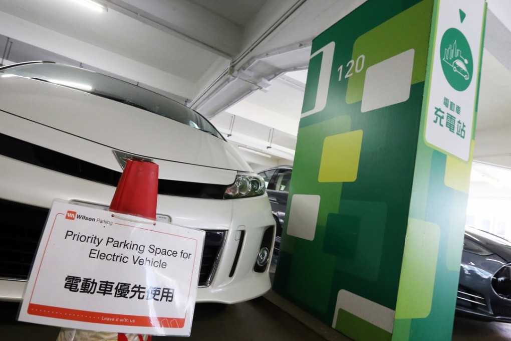 Pylons with “electric vehicle priority” signs are places in some spaces, but they are often moved aside by petrol car drivers. Photo: Dickson Lee