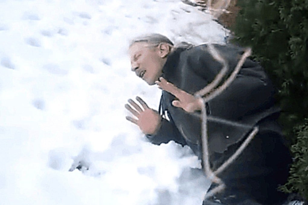 David Kassick lays on the snow-covered ground in pain after a police officer shot him with a Taser gun. Moments later the officer shot him dead. Photo: SCMP Picture