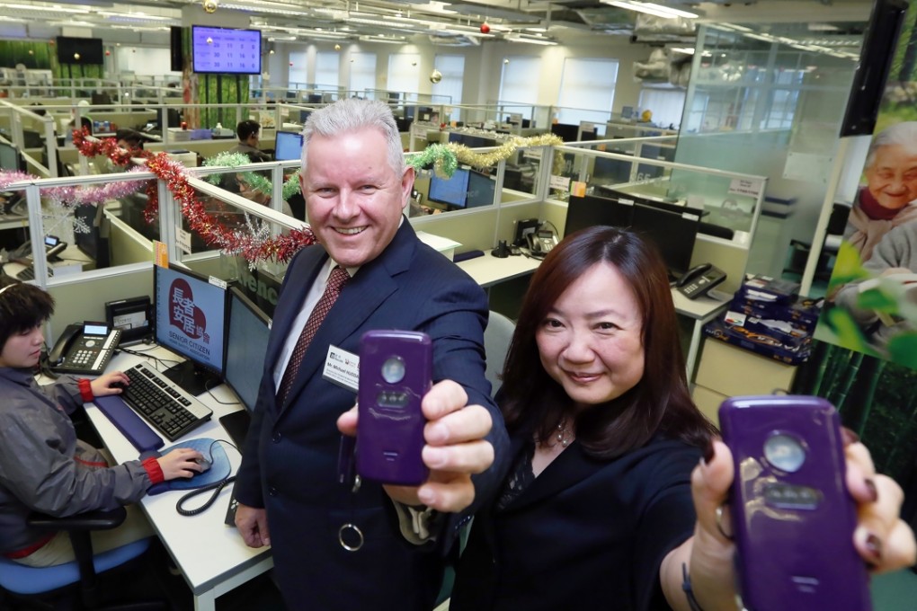 Michael Huddart, Manulife executive vice president and general manager, Greater China and Irene Leung, Senior Citizen Home Safety Association CEO with Mobile Link devices. Picture: Nora Tam
