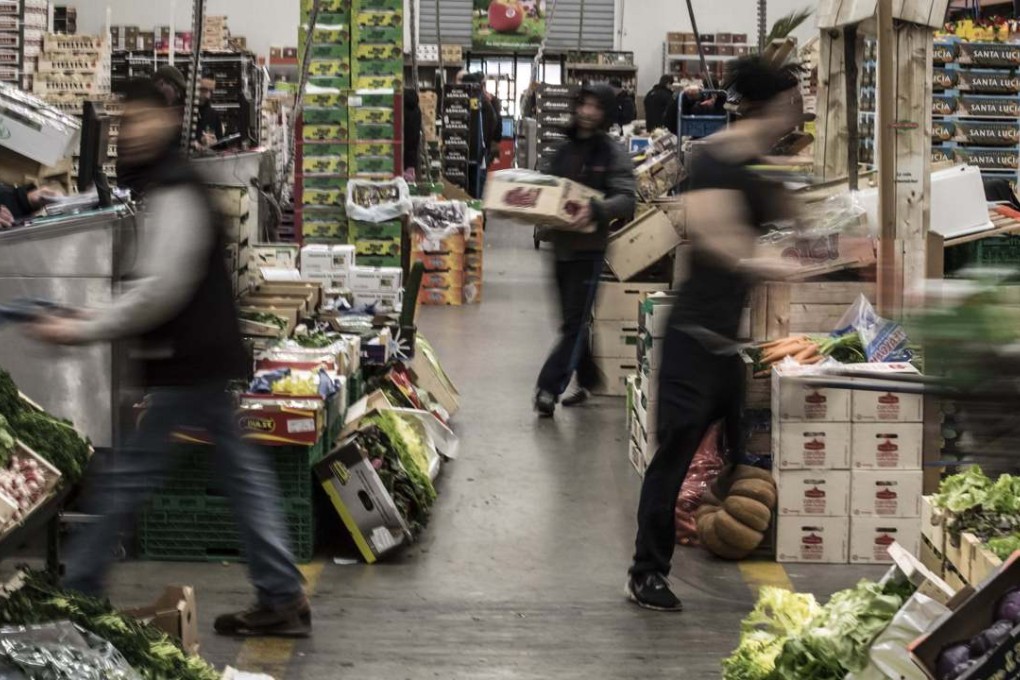 Vegetable wholesalers handle different kinds of vegetables at the wholesale market in Lyon Corbas, in France as the issue of food security becomes more vital in the years ahead. Photo: AFP