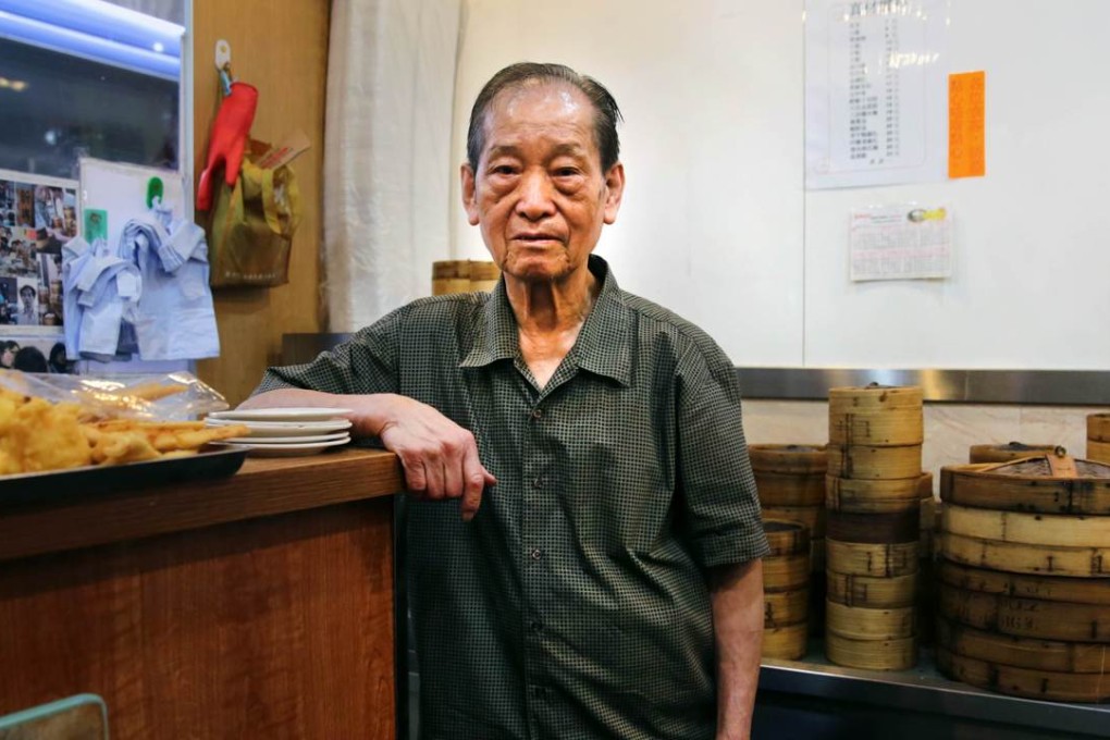 Chui Hoi stands at the front counter of his Sun Hing dim sum restaurant in Kennedy Town, Hong Kong. With much of the city's famous snacks now factory made, a core of dedicated chefs are determined to prevent the hand-made tradition from dying out. Photo: AFP