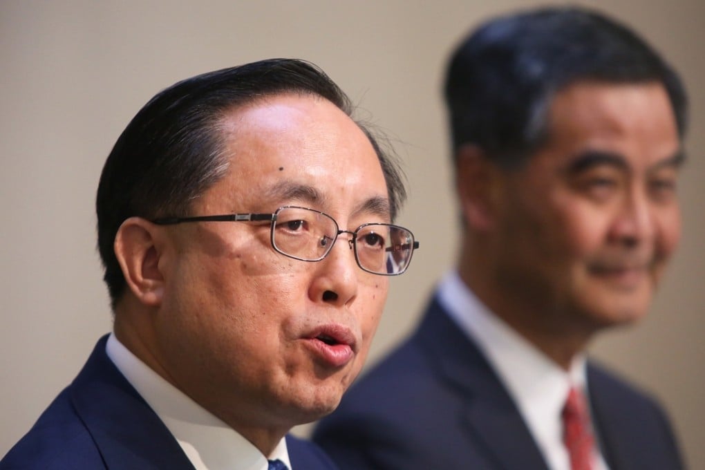 Nicholas Yang with Leung Chun-ying speaking before media today in Admiralty. Photo: Sam Tsang