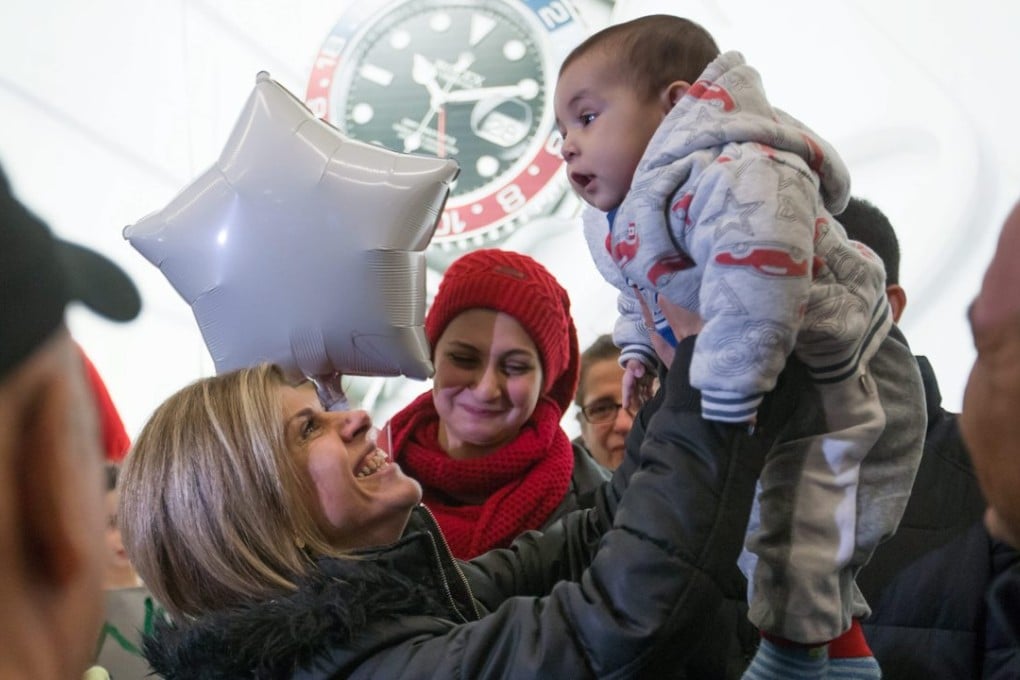 Tima Kurdi, left, who lives in the Vancouver area, greets her five-month-old nephew Sherwan Kurdi at Vancouver International Airport on Monday. Photo: AP