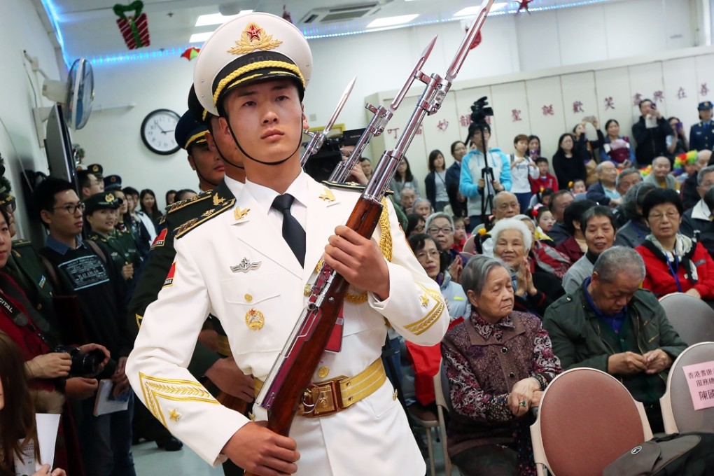 People’s Liberation Army troops visit the Hong Kong Society for the Aged’s Madam Ho Sin Hang Home for The Elderly in Pok Fu Lam. Photo: David Wong