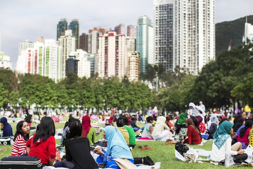 Domestic helpers socialise in Victoria Park on their day off.