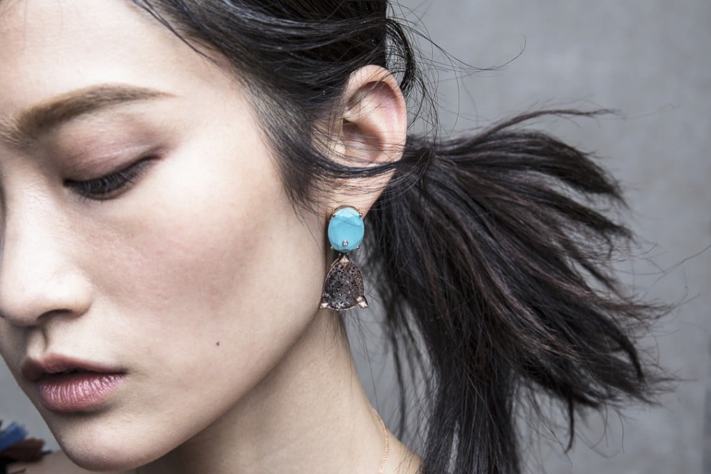 A model wearing a Turquoise, diamond and smoky quartz earrings in 18k rose gold by Lama Hourani. ]