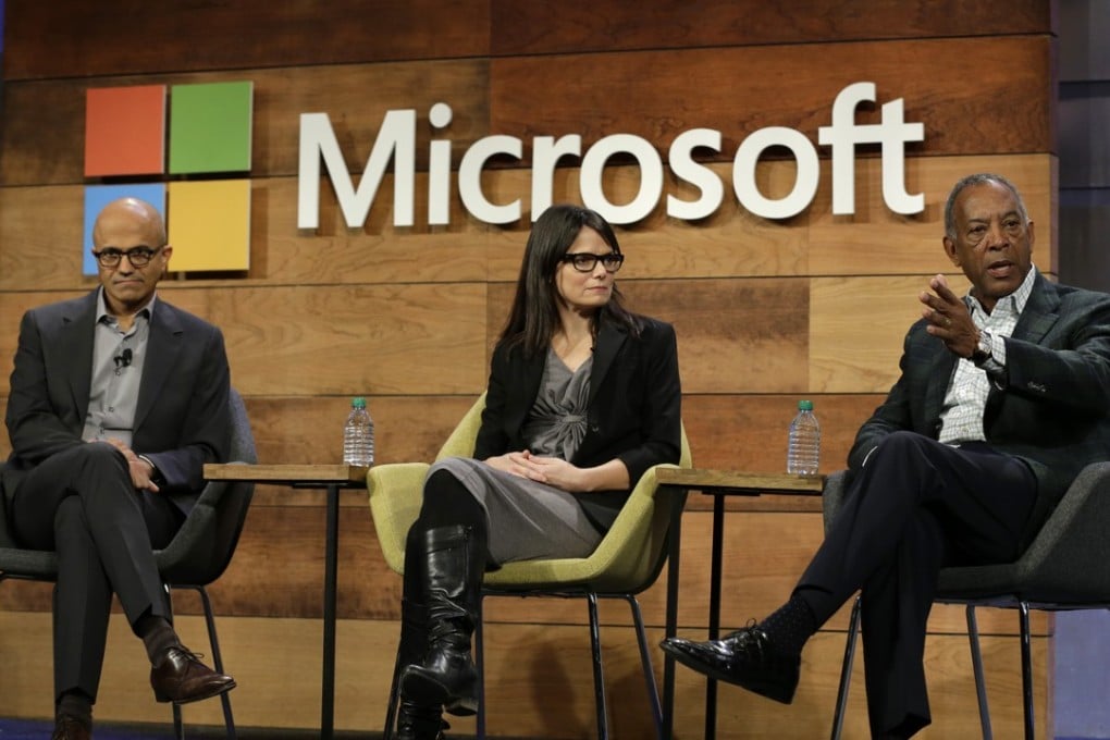Microsoft chairman John Thompson (right) addresses the company's annual shareholders meeting this month as chief executive Satya Nadella and chief financial officer Amy Hood look on. Photo: AP