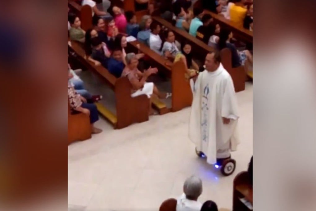The priest sings as he rides a hoverboard down the church aisle. Photo: SCMP Picture