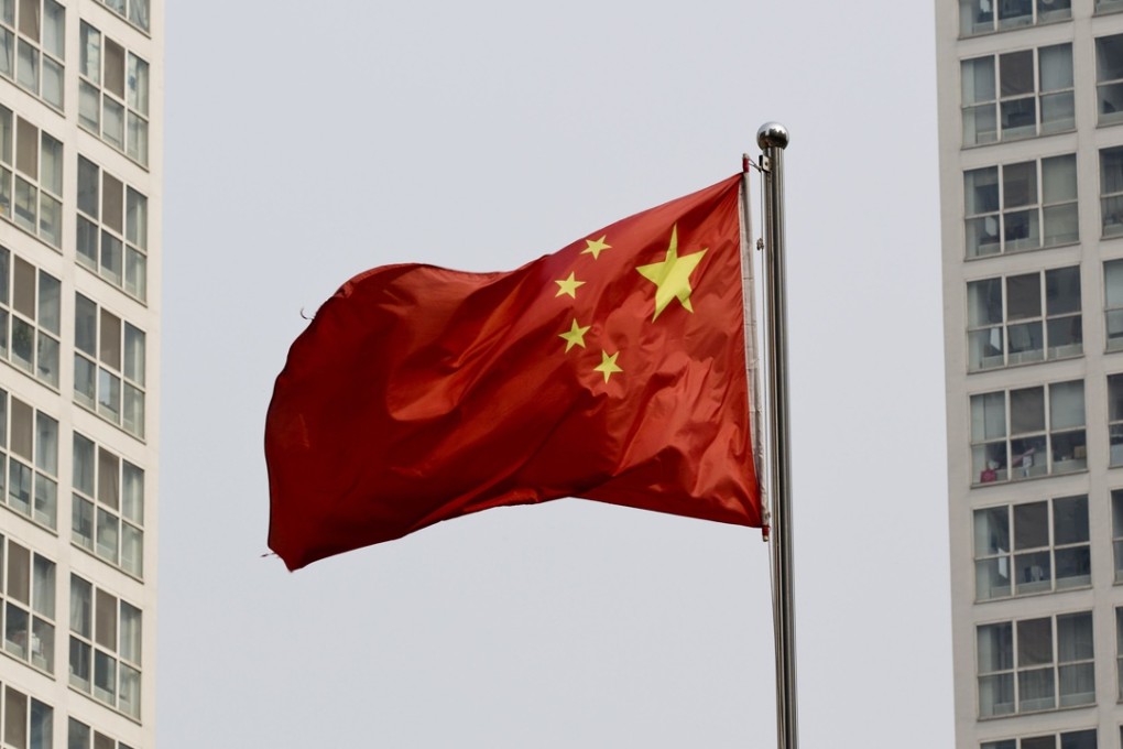 A Chinese national flag flutters in the wind between a high-rise residential and office complex in Beijing, China. The property market is now looking toward the housing policies by the government going into 2016. Photo: AP