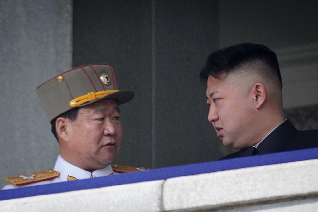 Choe Ryong-hae talks with North Korean leader Kim Jong-un at a military parade in Pyongyang in 2013. Choe was purged and sent for “re-education”. Photo: AFP