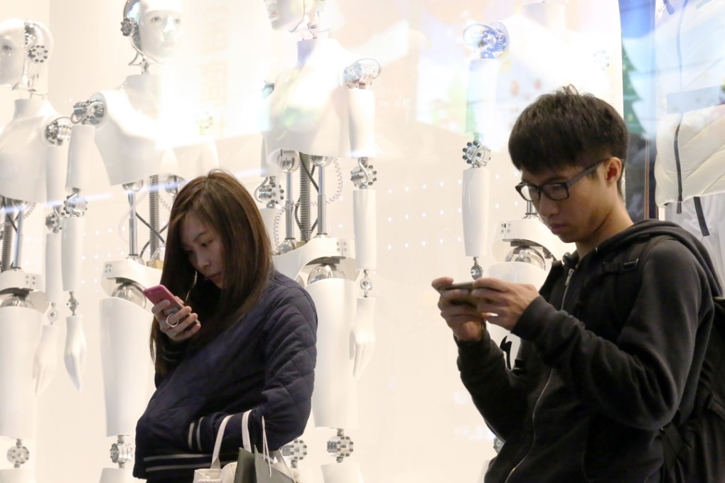 Hongkongers hunched in a posture of prayer over their smart devices. Photo: Nora Tam