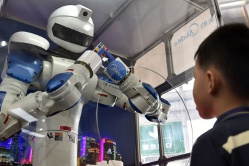 A robot solves a Rubik’s Cube in record time at the China International Internet Plus Exposition in Foshan, Guangdong province in September. Robot companions are expected to start popping up in 2016. Photo: Xinhua