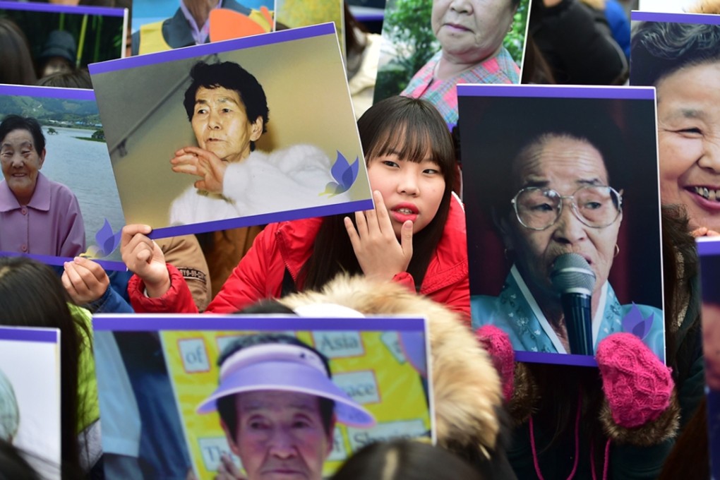 South Korean supporters hold portraits of former "comfort women", vowing to step up protests against a deal between Seoul and Tokyo on resolving a long-running row over the comfort women. Photo: AFP