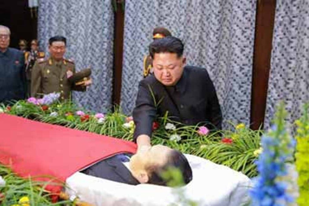 North Korean leader Kim Jong-un tearfully touches the face of his aide Kim Yang-gon, who was reportedly killed in a car accident. Photo: Yonhap