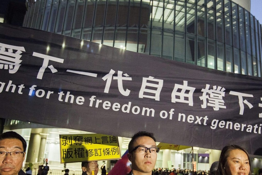 Security guards stand guard at a rally organised by members of rights group Keyboard Frontline outside Hong Kong's Legislative Council Complex. Photo: EPA