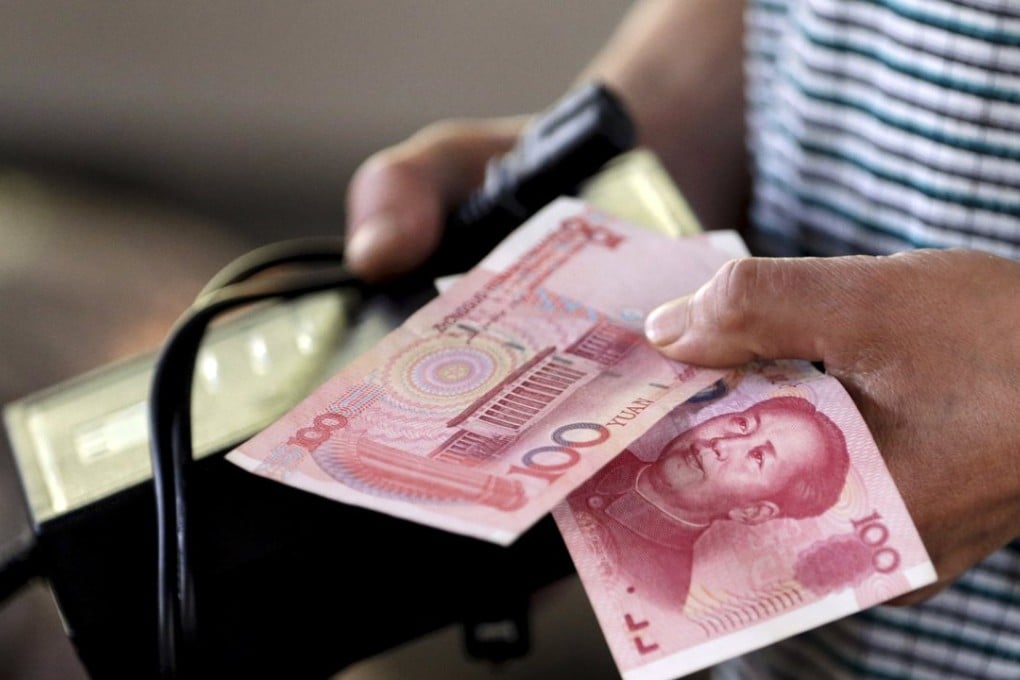 A customer holds a 100 Yuan note at a market in Beijing, China as developers continue to tap the onshore bond market. Photo: Reuters