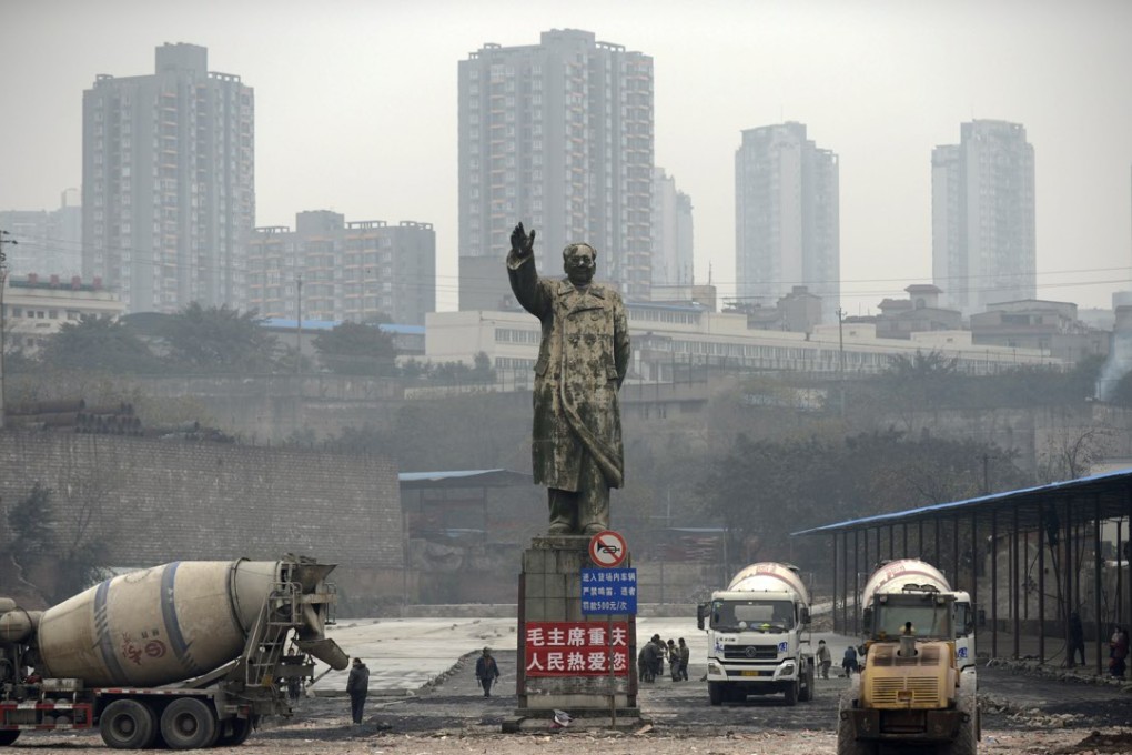 Cement mixers park on a construction site near a statue of Mao Zedong in Chongqing. The city’s double-digit growth remains the highest in China. Photo: AP