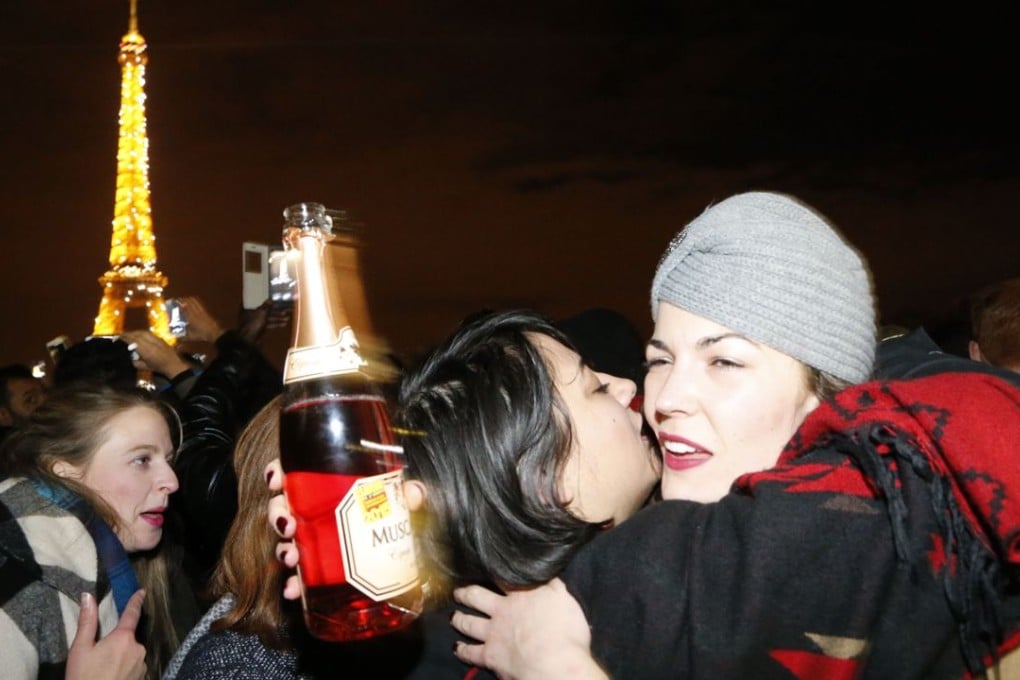 Revellers embrace near the Eiffel tower during New Year celebrations in Paris, where terrorism fears still loomed large. Photo: AFP