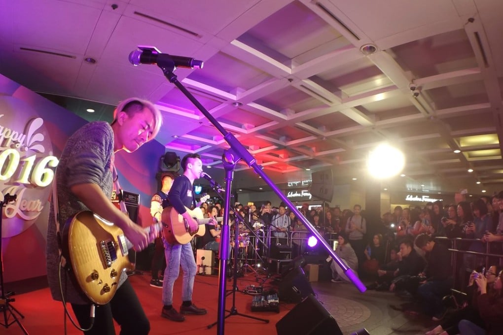 Local band Super Moment performing to the crowds at Times Square, Causeway Bay to mark the celebration of the New Year yesterday evening. Photo: Martin Chan