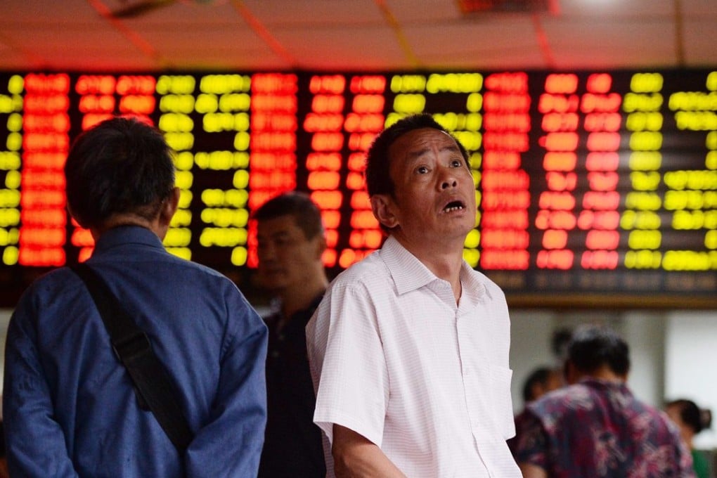 A stock investor checks prices in a brokerage house in Shanghai, China. Photo: EPA