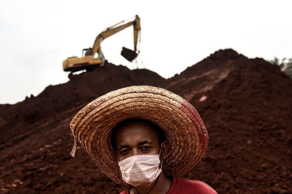 A worker at a bauxite storage site in Bukit Goh situated in Malaysia's rural state of Pahang. Demand for bauxite, which is used in aluminium production, is soaring - fuelled by heavy demand from China. Photo: AFP