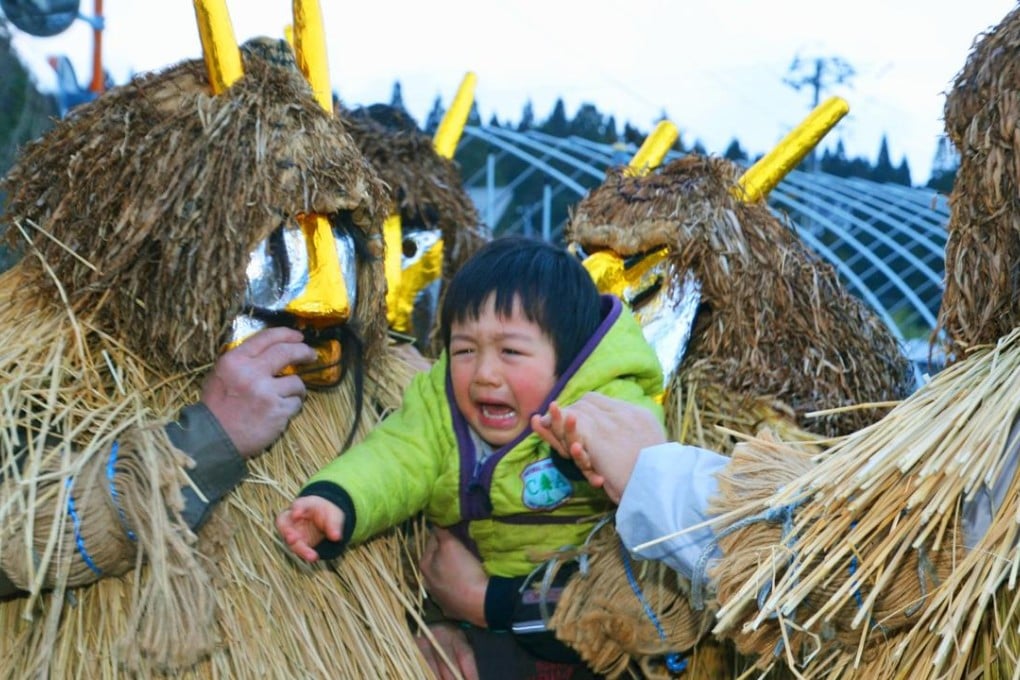 Young men wearing fierce-looking masks resembling imaginary demons known as “oni” and straw capes visit each house on New Year’s Eve, shouting to check whether there is a disobedient child or lazy person in the family. Photo: Kyodo