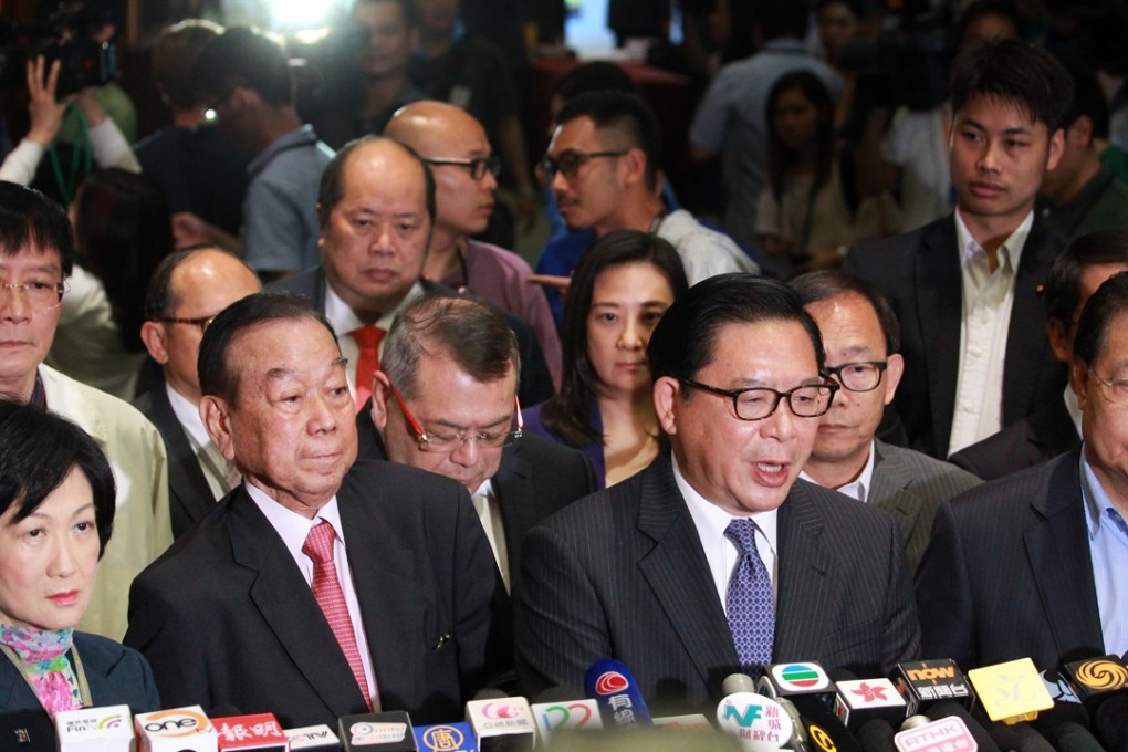 Pro-Beijing legislators (from front left) Regina Ip Lau Suk-yee, Lau Wong-fat, Jeffrey Lam Kin-fung, and Tam Yiu-chung meet the press after the reform package was rejected.