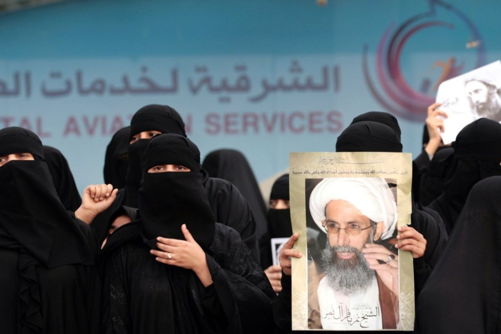 Saudi Shiite women hold placards bearing portraits of prominent Shiite Muslim cleric Nimr al-Nimr during a protest in the eastern coastal city of Qatif against his execution by Saudi authorities, on January 2, 2016. Photo: AFP