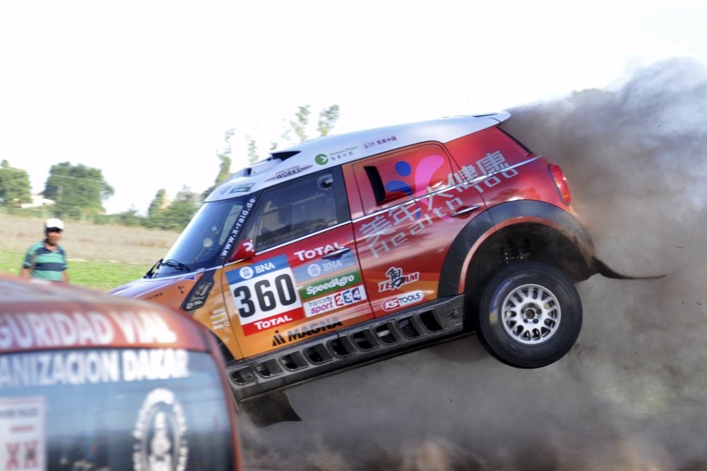 Guo Meiling, of China, jumps her Mini into the road during the 38th Dakar Rally prologue in Arrecifes, Argentina. Photos: Reuters