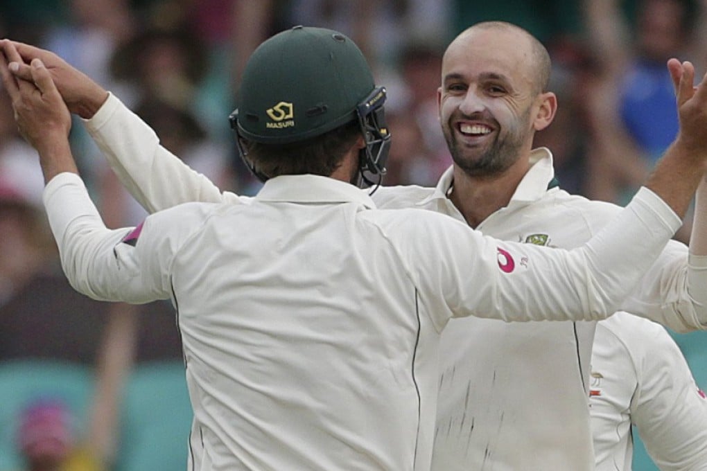 Australia's Nathan Lyon celebrates his 100th test wicket on Australian soil in the third test against the West Indies in Sydney. Photo: Reuters